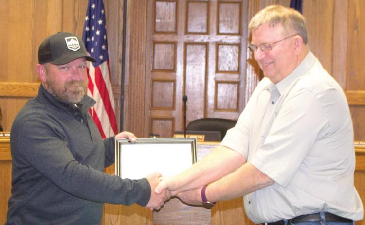 Mayor Grant Spieth presents resigning Columbus City Council Ward 4 Member Nate Long with a certificate of accomplishment at Monday night’s city council meeting. “It’s been good,” Long said, addressing the council. “I appreciate each and every one of you.” Photo by Jacob Spencer