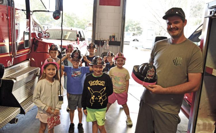 Youngsters in Rylee Crain’s Central second grade class toured the Columbus Fire Department during Fire Prevention Week. Fire Fighter Hunter Burton, passed out fire hats for the youngsters to take home.