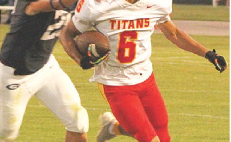 Titan Freshman, Jaydan Dohle, breaks away from Senior, Evan Wittenmyer as he takes off on his 80-yard catch and run touchdown from sophomore, Cole Howard in Friday’s 13-20 loss in Galena.