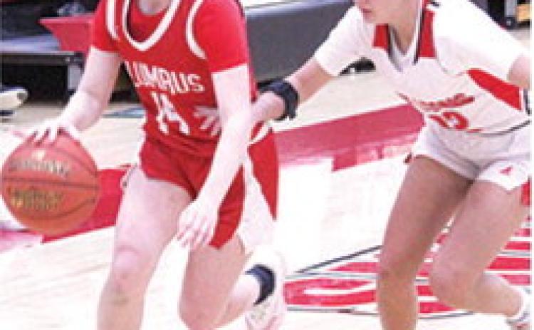 Lady Titan Junior, Bentley Townsend, drives past junior, Layla Weaver, on her way to the basket in Friday’s homecoming win over Baxter Springs, 4126. Bentley led the Columbus with 11 points.