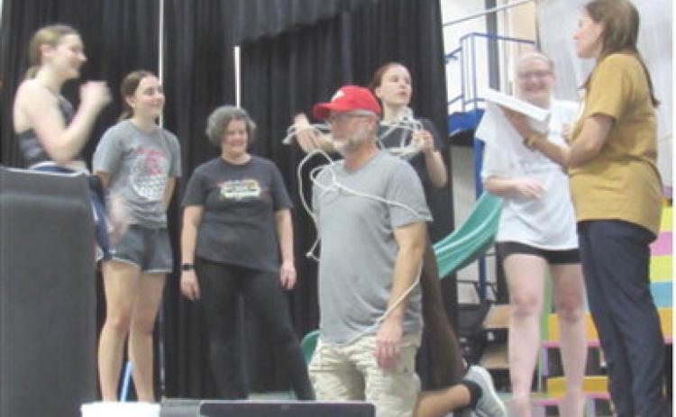 Cast members of 9 to 5: The Musical, rehearse a scene. Actors include ladies left to right: Khloee Cox, Mallory Thompson, Michelle Atchley, Madalyn Weeks, Kaylee Denton and choreographer Melissa Thompson-Holt. Center Chad Fletcher in the role of Franklin Hart. Courtesy photo.