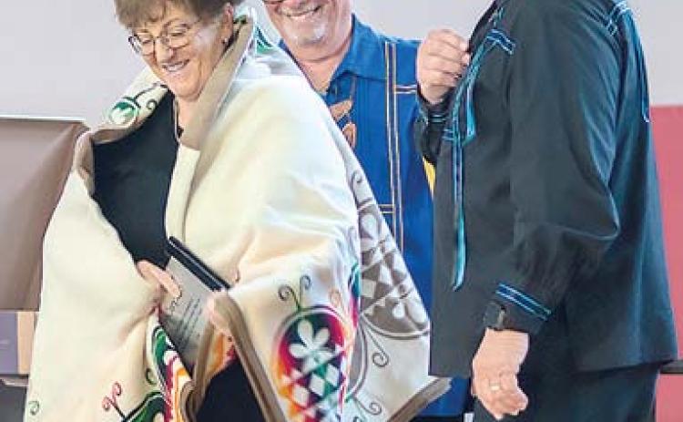Columbus resident Kelly Carpino was awarded the tribe’s Honored Person award at the Wyandotte Nation of Oklahoma Annual Meeting recently. Presenting the award was tribe Chief Billy Friend and Second Chief Norman Hilderbrand. Photo courtesy William Swaim-Wyandotte Nation,