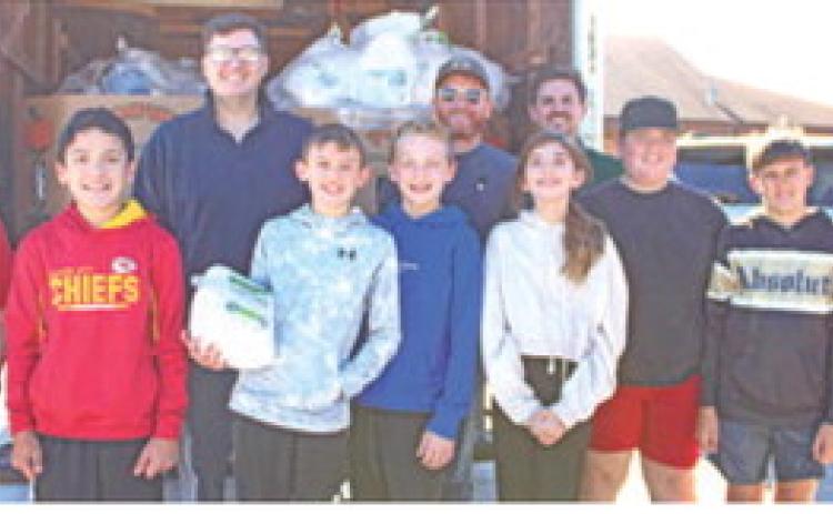 Jake LaTurner, Jake Conard and Daniel Koucky were joined by Columbus sixth graders to unload turkeys to be used in the Thanksgiving baskets.