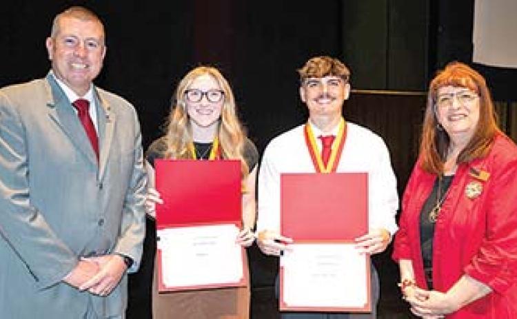 Teacher of Promise awards were presented to Columbus High School graduate Jaxson Haraughty (center) and Mia (Anderson) Beebe of Spring Hill during ceremonies at the Bicknell Family Center for the Arts. The awards were presented by Associate Dean Jason Clemensen (at left) and Jean Dockers, director of the teacher education program at Pitt State (at right).
