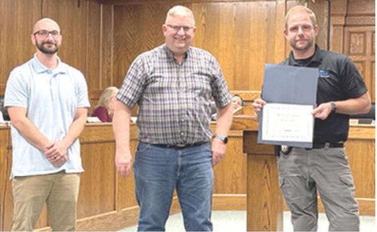 At the Monday night Columbus City Council meeting, Chief of Police Kyle Clark (at right) was presented a certificate of recognition for his five years working with the City. Presenting the award were Jake Letner, City Administrator and Grant Spieth, Mayor.
