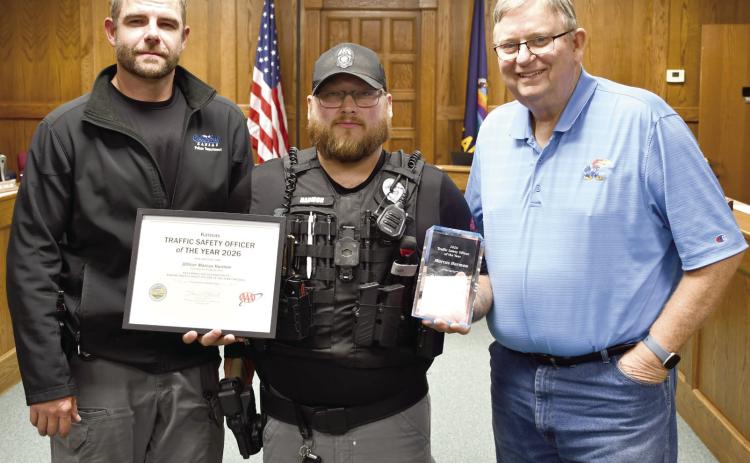 Officer Marcus Harmon, center, stands with Columbus Police Chief Kyle Clark, left, and Columbus Mayor Grant Spieth, right. He is the first recipient of the Kansas Traffic Safety Officer of the Year award presented at the Annual Impaired Driving Conference held in Wichita October 5 and 6.