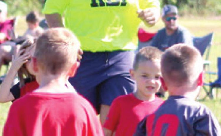 Referee, Kody Schalk, traded his Friday night football pads for a Saturday morning soccer ref shirt as the Columbus Area Youth Soccer League got underway, Saturday at Eddington Park. Courtesy Photo.