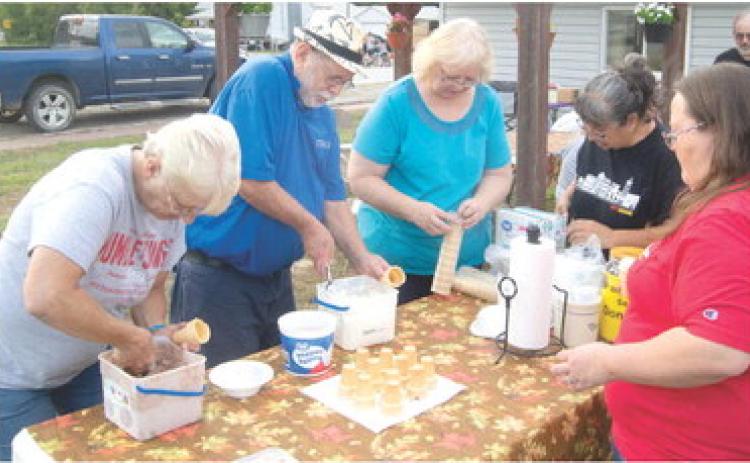 Dipping ice cream cones Friday night at the Weir Homecoming were Kay Lynn Jites, Bill Holden, Cathy Colden and Sue Ann Barnes.