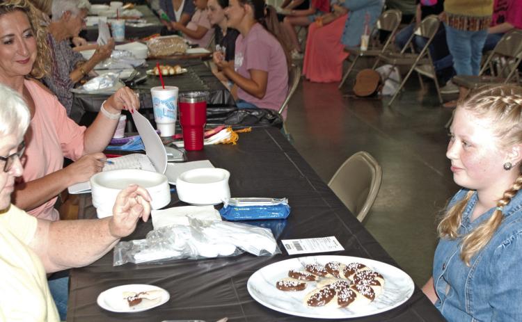 Violet Huddleson talks to the judges about her chocolate dipped cookies. Huddleson was participating in the foods judging held at the 4-H Building July 17. Photo by Destynne Goff.