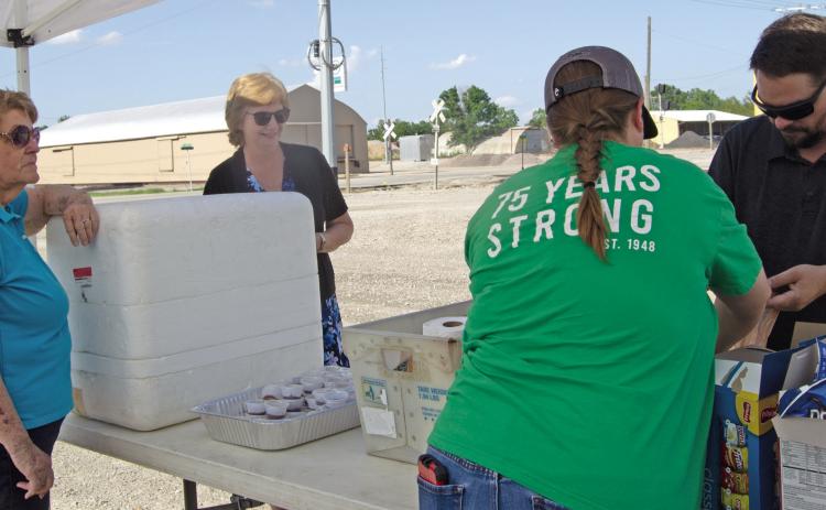 Columbus Chamber members sack up burgers, chips, water and condiments to be taken to the fields to Feed the Farmers. Working were Chamber Executive Director Jean Pritchett, Josie Welch, Spring Valley Leader and Matt Case, Manager of Farmer Co-op. Jeanette Crain was making the deliveries.
