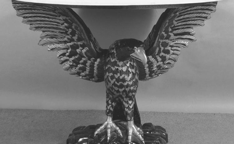 Eagles are a powerful symbol in American designs from the Great Seal to everyday decorative arts. A carved eagle holds up this table’s faux marble top.