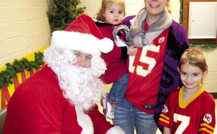 After the Scammon Christmas parade, Santa made a stop to visit with the children. Hazel Kimmnon, Kaya Kimmon and Raci Kimmon took some time to chat with him.