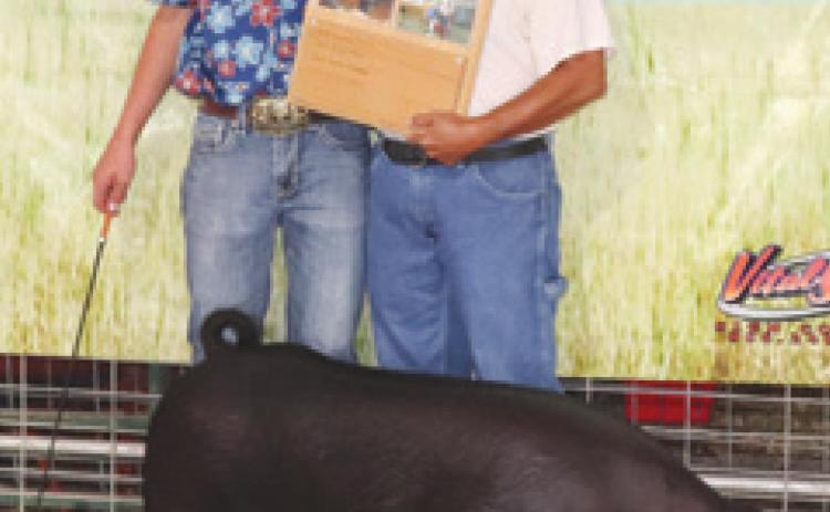 Cherokee County 4-H member Cole Youngblood was awarded the Buck Sharp Swine Award during the county fair. Anne Sharp presented the plaque. Youngblood was Grand Champion in Senior Fitting and Showing and Grand Champion in Market Hogs,
