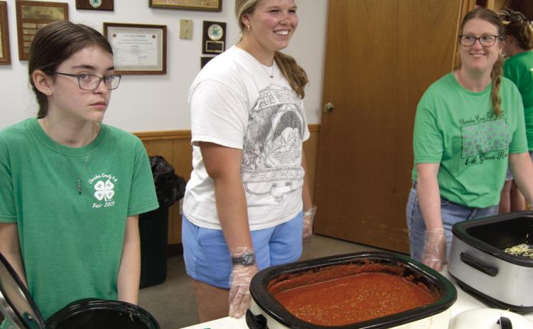 Plenty of help turned out for the fundraiser for the 4-H Building June 7. Kora Welch, Emma Walker and Laura Holmes were working in the serving line dishing up spaghetti with meat sauce and green beans. Funds raised will go to refurbishing the 4-H Building.
