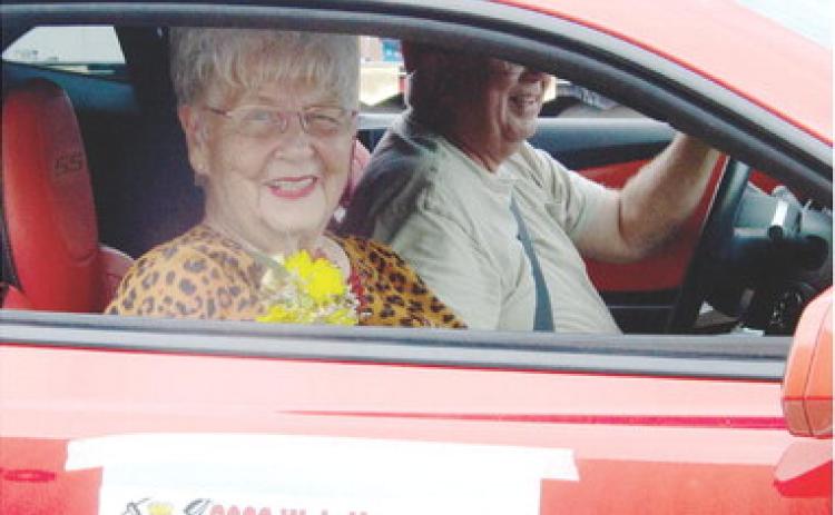 Weir Homecoming Parade Grand Marshal Karen Jeanette Sullivan waves to the crowd as she travels along the parade route during Saturday’s 88th annual parade.