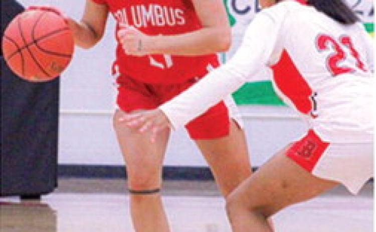 Lady Titan Sophomore, Americus Woodcock, drives past Lady Lion Sophomore, Faith Murray, in the January 16, Columbus win in Baxter Springs. Americus scored six points in the Lady Titan loss to Commerce, Okla. in the 2026 Lancer Classic opening round, Monday, 26-43.