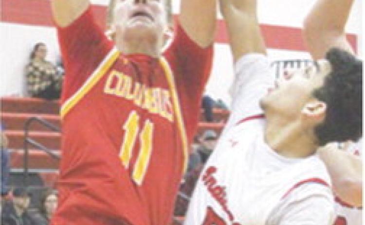 Titan Sophomore, Jonas Stover, scored 27 points in the Columbus season opener at Oswego. Demitri Wiliamson, Indian Sophomore, defends. Williamson led Oswego with 16 points.