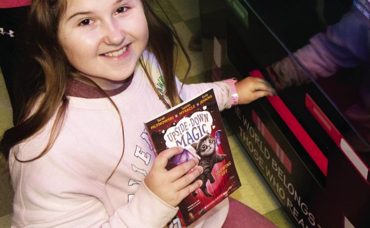 A ribbon cutting ceremony was held Wednesday for the new book vending machine installed at Central Elementary in Columbus. Addlyn VanGilder showed off her newly chosen book.