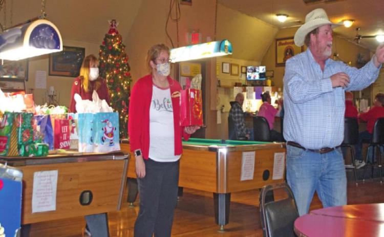 Auctioneer Phillip Bass works the crowd at the West Mineral Eagles Lodge into purchasing various bagged items as part of the fraternity’s fundraiser. Members bid on over 40 items throughout the afternoon, allowing the group to collect $1,161.50 to donate to various health organizations.