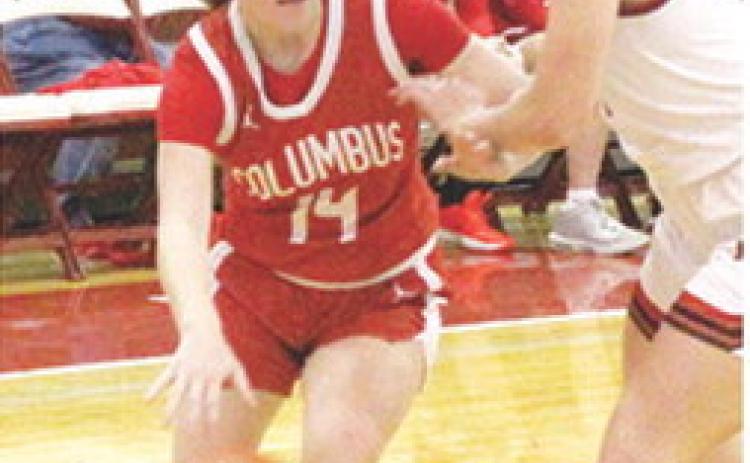 Lady Titan Junior, Bentley Townsend, drives to the basket past Oswego Freshman, Colby Pease in the, 31-28, Columbus season opening win at Oswego. Bentley scored eight points in the win.