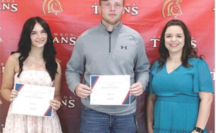 Allison Burns and Brandon Stice received the Columbus Junior, Senior High School Business Scholarship in the amount of $350 each from USD 493 Business Instructor, Laura Boeckman during the 2025 Senior Assembly, May 16, at the Columbus Unified High School Gymnasium.