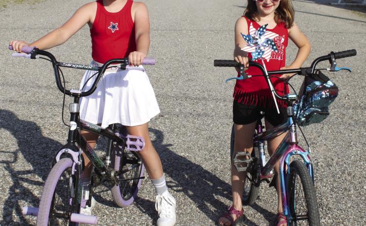 Maci Livingston and Abigail Moeckel finished first in the girls bicycle division of the Fourth of July 5K.