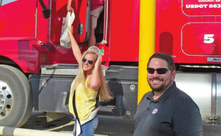 Farmer Julie Schultz receives a lunch from Miss Columbus Anna Holman and Matt Case at last year’s Feed the Farmer event. Watch the Coop for this year’s event that will be held some time during wheat harvest.