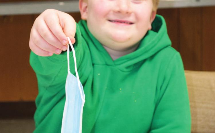 Easton Haywood was handing out masks at the goat and sheep meeting on Thursday evening in the 4-H building. The meeting gave 4-H’ers and professional goat and sheep shepherds a chance to discuss problems in the business.