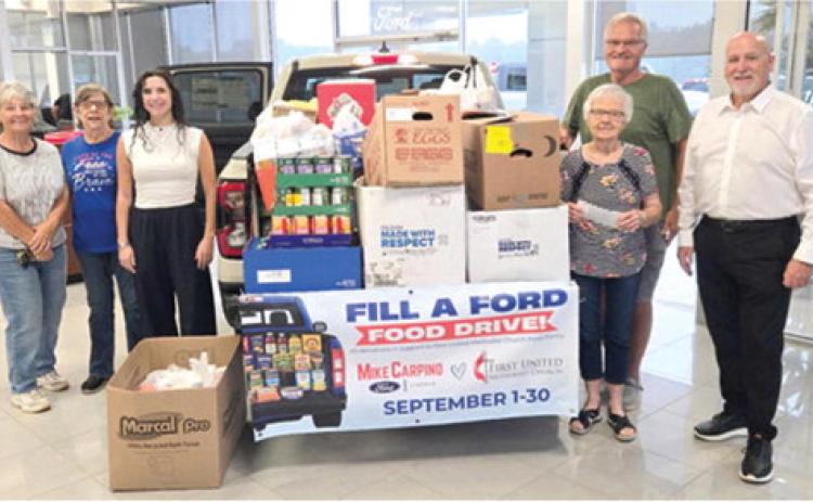 Recently members of the First United Methodist Church picked up donations collected at Mike Carpino Ford. During the month of September members of the community dropped off items at the Columbus location for donation to the FUMC food pantry. Hannah Carpino and Mike Carpino presented the items to the church. Courtesy photo.
