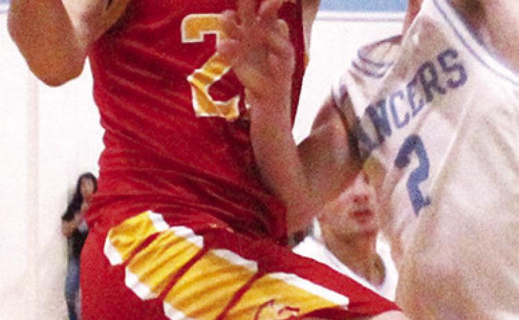 Titan Senior, Cole Minor, goes to the hoop against Lancer Senior Drake Guymon in the 57-41 Titan win at Southeast, Friday.