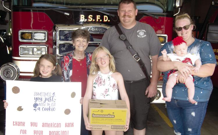 The Baxter Springs Girl Scouts received a helping hand from American Bank as the bank purchased several cases of Girl Scout Cookies which had gone unsold. The girls then delivered the cookies to the Baxter Springs Fire Department as a thank-you to the men and women in the department. American Bank vice-president Judy Hill was joined by Girl Scouts Kinley Capps and Sutton Russell as they presented the cookies to John Hunt with Baxter Fire Department.