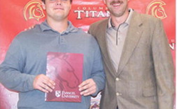 Carter Henry received three scholarships from Evangel University during the Columbus Unified High School Senior Assembly, May 16, at the CUHS Gymnasium. He received a $14,000 Academic Scholarship, a $3,000 Football Scholarship, and a $1,000 Sibling Scholarship from presenter, Matt Crain, USD 493 Instructor.