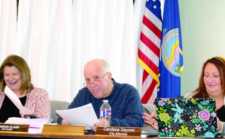 Newly sworn-in Mayor Kelly Abbott took his place at the end of Tuesday’s City Council meeting. He is between City Clerk Sharon Clark and City Attorney Candace Gayoso.