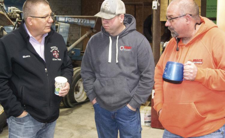Chamber of Commerce member Shawn Carter visits with Mike Bartling and Mike Boesker of Hammer Tires and Service at the Chamber of Commerce Third Thursday coffee. This is the first coffee after the COVID pandemic had caused the monthly event to be discontinued.