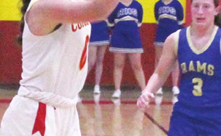 Lady Titan Freshman, Katy Mooney, shoots one of her four, three-point shots as Lady Ram Junior, Chloe Parker looks on. Katy led all scorers with 16 points in the Columbus 31-43, loss to Riverton, Tuesday. Parker scored 13 points to lead the Lady Rams in scoring.