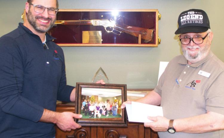 Saying farewell to a long-term employee, American Bank President Taylor Hight presented retiring teller, Dennis Webb a photo of the bank’s staff, plaques and other gifts. Webb worked in the Baxter Springs office of the bank for 20 years. The public is invited to a special retirement reception for Webb January 14 from noon-3 p.m.