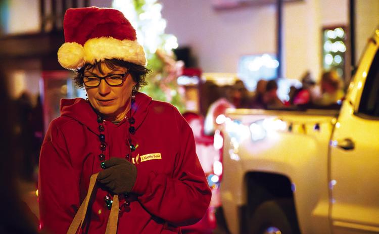 Kelly Robison from Labbette Bank walks along the parade passing out candy to youngsters.