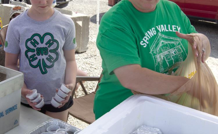 Riley Holmes and Josie Welch sack up burgers to “Feed the Farmers,” to fill the orders.