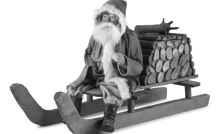 Leave it to Santa Claus to fill a bundle of firewood with candy! This papiermache figure of Santa on a sled is a candy container.