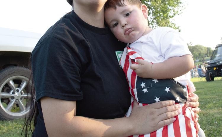 Light up the Sky event held at Kiwanis Park in Baxter Springs was a sea of red, white a blue as residents and visitors gathered to celebrate the nation’s Semiquincentennial. Cohen Moates, in the arms of his mother Josefina Moates, shows off his festive digs.