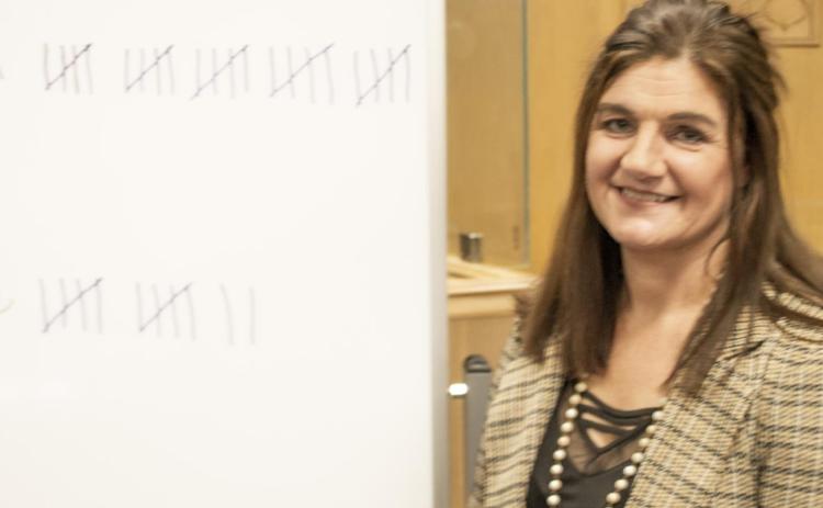 Newly elected Clerk Rebecca Brassart stands beside the total board used to record the votes during the Republica Convention held Tuesday evening in the District Court Room of the County Courthouse. Brassart has worked for the County for 19 years and is a lifelong resident of the county.