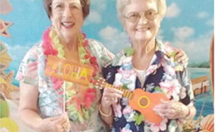 A Hawaiian luau theme was chosen for the Annual Convention of the Kansas State Chapter of the P.E.O. Sisterhood held in Manhattan. Local members Mary Kirkpatrick and Alma Cook, along with their husbands Jim Kirkpatrick and Paul Cook, were in attendance. Courtesy photo.