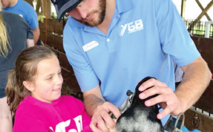 Chastin Leggett shown with one of his students during a livestock camp. More than 2,500 students will be in the camps this summer. Courtesy photo.
