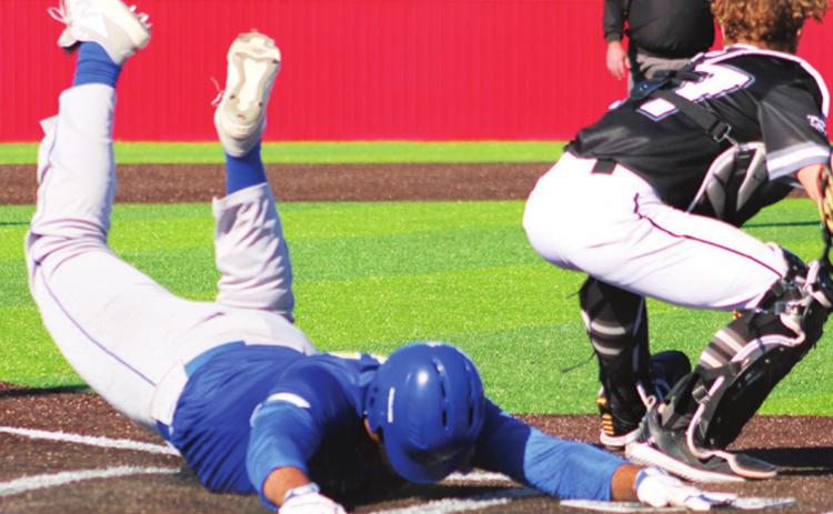 Jaylen McGuire slides safely home for the game winning run, giving the Riverton Rams the seventh inning, come-from-behind win, 5-4, over Wyandotte, Okla., Saturday in Seneca, Mo.