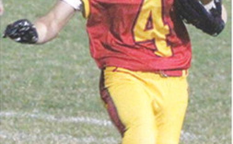 Columbus Junior High Seventh Grader, Dayton Hughes, gets a short gain around the end in the 0-0 tie with the Labette County Grizzlies, Monday, at Titan Stadium.