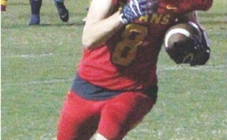 Titan Junior, Jace Midgett, makes the catch at the five yard line and scrambles into the end zone for the first Titans points of the game in the, 12-8, Columbus win over Galena, Friday.
