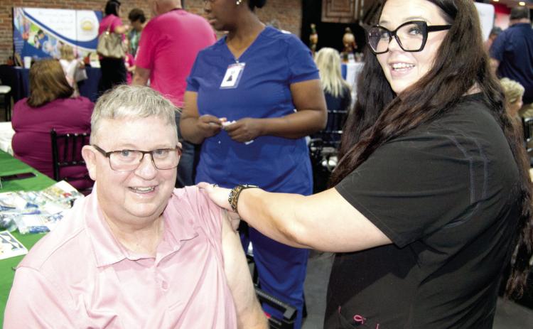 Columbus Mayor Grant Spieth received his annual flu shot at the Community Health Center of SEK during the Chamber of Commerce Expo Thursday.