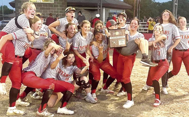 The Columbus Lady Titans celebrate after receiving their Kansas Class 3A Regional Championship plaque, Wednesday, at Rockette Field in the Columbus Community Field Ballpark. The Lady Titans are seeded third in the Kansas Class 3A State Tournament in Manhattan and will play the 7 p.m. quarterfinal game, Thursday, against Rossville (17-4), the sixth seed. The tournament is being hosted at the Twin Oaks Complex.
