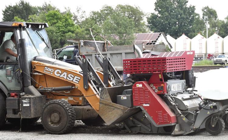 City of Columbus crews have been working to grind streets ahead of planned resurfacing later this fall. The new milling machine, shown attached to one of the city’s backhoes, has experienced issues in recent weeks resulting in its temporary retirement. City Superintendent Randy Coble expects it to be back to work in the coming weeks.