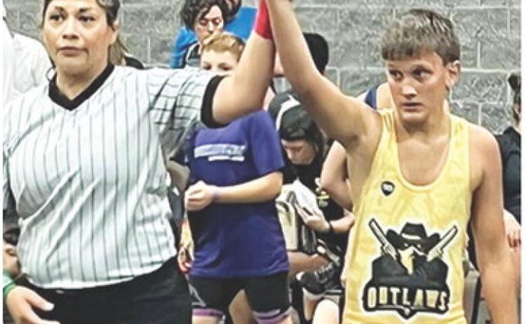 Briggs Johnson has his arm raised in victory following a match in the Cowboy Rumble at Branson, Mo., August 2-3. Courtesy photo.